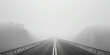© AngrySun - Minimalistic misty empty highway. Foggy road. Mystery travel concept. Generative AI