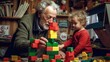 © MADMAT - Grandpa helped his two-year-old grandson build a tower with colorful blocks.