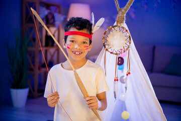 Sticker - Photo of cheerful kid prepare for halloween party in kindergarten wear native american costume indoors evening nursery room