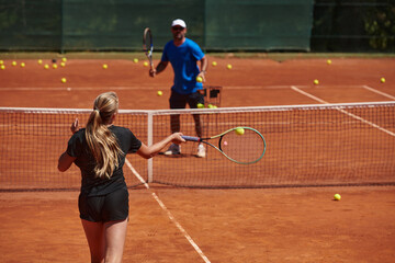 A professional tennis player and her coach training on a sunny day at the tennis court. Training and preparation of a professional tennis player