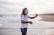 © Austockphoto - dharawal man at the beach explaining and pointing