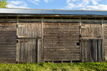 Old Weather Worn Structure Of Wooden Stables On Farm In Sunlight