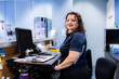 © Austockphoto - Portrait of female receptionist working at physiotherapist front desk office