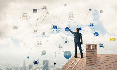 Wall Mural - businessman on house roof presenting networking and connection c
