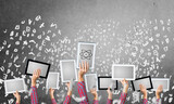 Fototapeta  - Close of woman hands in line showing tablet pc against concrete wall