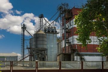 Wall Mural - agro silos on agro-industrial complex and grain drying and seeds cleaning line.