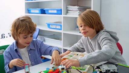 Wall Mural - robotics programming class. children construct and code robot. stem education using constructor bloc
