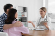 © New Africa - Couple having appointment with fertility doctor in clinic. Patient consultation