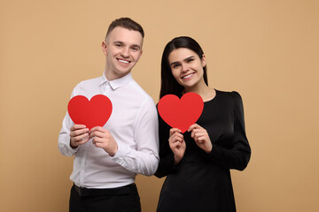 Wall Mural - Lovely couple with decorative hearts on beige background. Valentine's day celebration