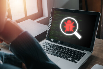 Software development and debugging concept, Person hand using laptop computer with bug software icon on screen, Software security, Computer bug, failure or error of software.