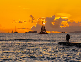 People Photographing The Sunset on The Queens Walkway Into The Ocean,, Waikiki, Oahu, Hawaii, USA