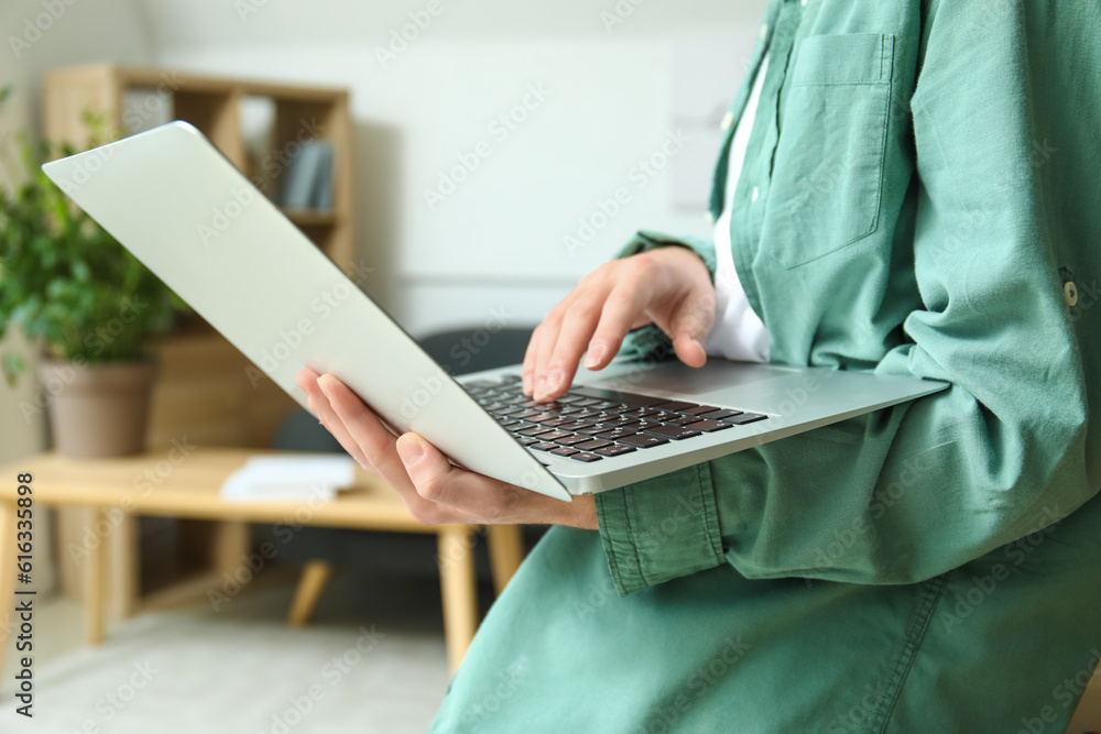 Male freelancer working with laptop in office, closeup