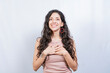 © IHERPHOTO - Positive woman with lovely sincere smile feeling thankful, relaxed person showing thank you gesture with hands on chest, Grateful people concept