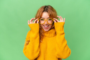 Wall Mural - young caucasian woman isolated on green screen chroma key background with glasses with happy express