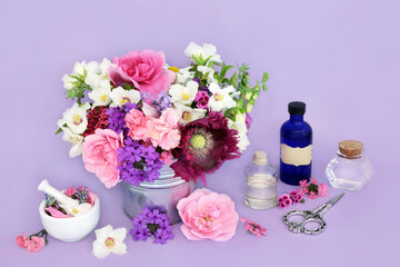 Wall Mural - Medicinal flowers and herbs for naturopathic herbal medicine. Flower essences for natural remedies on lilac background with essential oil bottles.