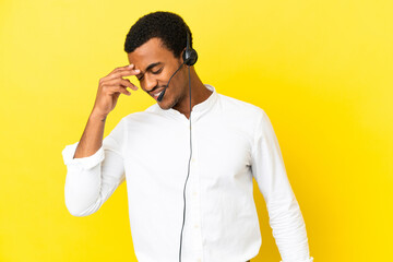 Wall Mural - African American Telemarketer man working with a headset over isolated yellow background laughing