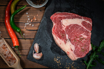 Variety of Fresh Raw Black Angus Prime Meat Steaks New York, Ribeye and seasoning on wooden background, top view