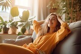 Fototapeta  - Happy woman relaxing on the sofa at home - Smiling girl enjoying day off lying on the couch, Healthy life style, good vibes people and new home concept