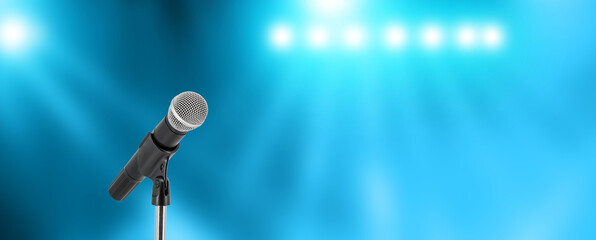 microphone with stage light background for performance concept of speech comment and public speaking