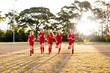 © Austockphoto - A tween girls football team running towards the camera sports oval