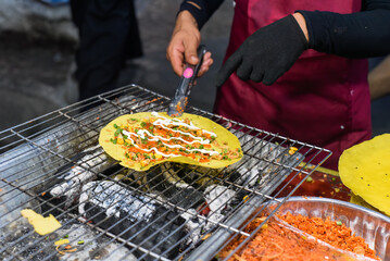 Wall Mural - Grilled vietnamese pancake with eggs, sausages and sauces in vietnamese night market in food festival