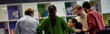 © Friends Stock - Rear view of multiracial business people communicating, sharing ideas and working together in the modern office or coworking space