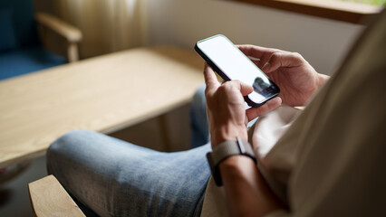 Wall Mural - Close up of person looking at mobile phone, Online social addict..