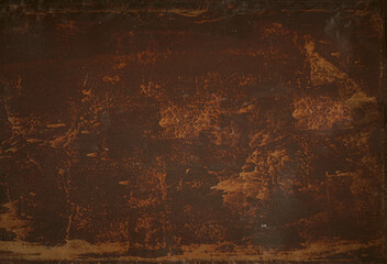 Brown beige abstract textured background with red hues. A weathered, rust-eaten textured sheet of metal with traces of paint residue. Artistic rust pattern on old paint.