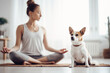 © Jasmina - Young woman practice yoga in her living room with her dog
