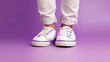 © Анастасия Козырева - Children's legs in white sneakers on a purple background. Close-up. Generative AI.