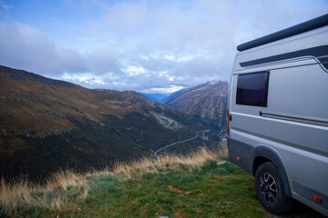 Camper cars on mountain road in fog. Caravan car trip.