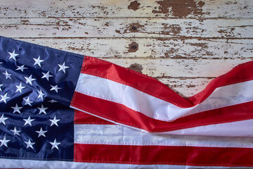 Wall Mural - American Flag for America's 4th of July Celebration over a white wooden rustic background to mark America's Independence Day. Image shot from the top view