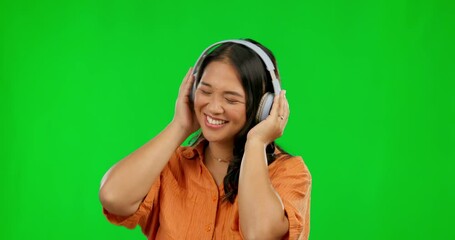 Sticker - Dance, radio headphones and woman on green screen in studio isolated on a background mockup. Music, listening and happy Asian person streaming audio, sound or podcast, jazz and dancing with energy.