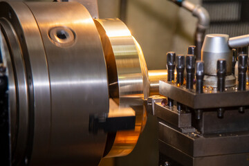 Closeup scene the lathe machine finish cut the brass parts by lathe tools.