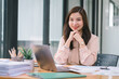 © PRIME STOCK LAB - A portrait of a smiling, young, beautiful, professional, and confident millennial Asian businesswoman using a digital tablet to analyze sales data at a modern office.