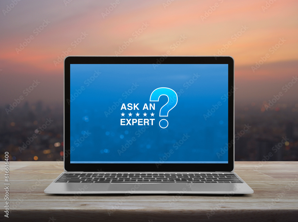 Ask an expert with star and question mark sign icon on modern laptop ...