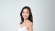 © khwanchai - Beautiful Asian woman smile with her smooth skin look at camera in action posing of a professional model on white background in studio light, Generative AI