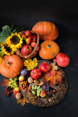 Wall Mural - Wiccan altar for Mabon sabbat. wheel of the year, fruits, pumpkins, flowers and autumn leaves on dark background. Witchcraft, esoteric spiritual ritual. autumn equinox holiday. harvest time. top view