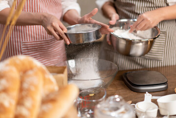 In the heart of her home, an Asian woman embraces the role of both baker and businesswoman