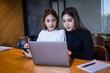 © EduLife Photos - Two cheerful young Asian female college students working on the school project using laptop computers and tablets together in private study room