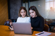 © EduLife Photos - Two cheerful young Asian female college students working on the school project using laptop computers and tablets together in private study room