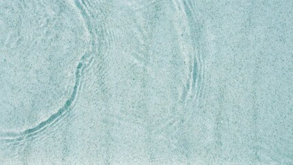 Wall Mural - abstract white sand beach with transparent water wave from above, calm rippled water surface background concept with space for text or product presentation