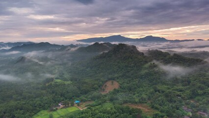 Wall Mural - 4k motion time lapse video aerial view morning scenery mist flowing over the high mountains the move
