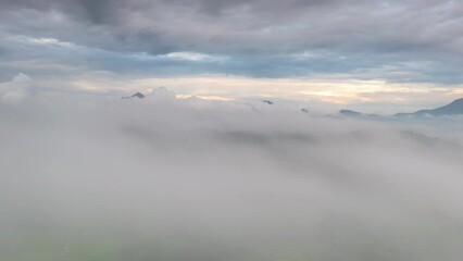 Wall Mural - 4k motion time lapse video aerial view morning scenery mist flowing over the high mountains the move