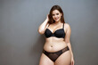 © Anatoly Tiplyashin - Curve  woman plus size model in lingerie on gray background. Generative AI