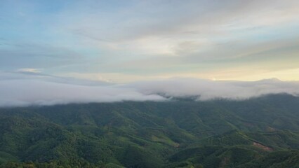 Wall Mural - 4k motion time lapse video aerial view morning scenery mist flowing over the high mountains the move