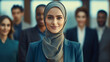 © annebel146 - Successful muslim business woman smiling confident with arms crossed female manager in office. Blurred team behind her on the background. Teamleader, Muslim boss concept. Powrful woman