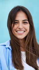 Wall Mural - Portrait young beautiful smiling woman looking camera with sky blue background. Fashionable girl in casual attire. Positive cheerful female Caucasian people confident posing sharing on social media. 