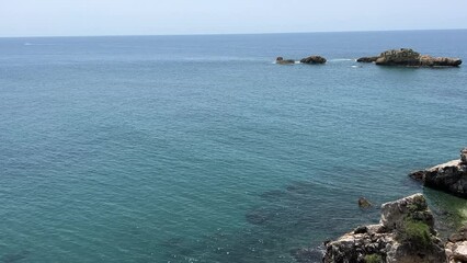 Canvas Print - Blue sea calm water and rocky coast.