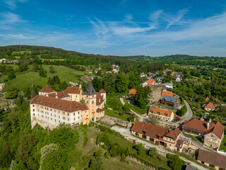 Wall Mural - Aerial view of Vimperk Renaissance chateau castle with fortified round gun tower above the medieval town with blue sky